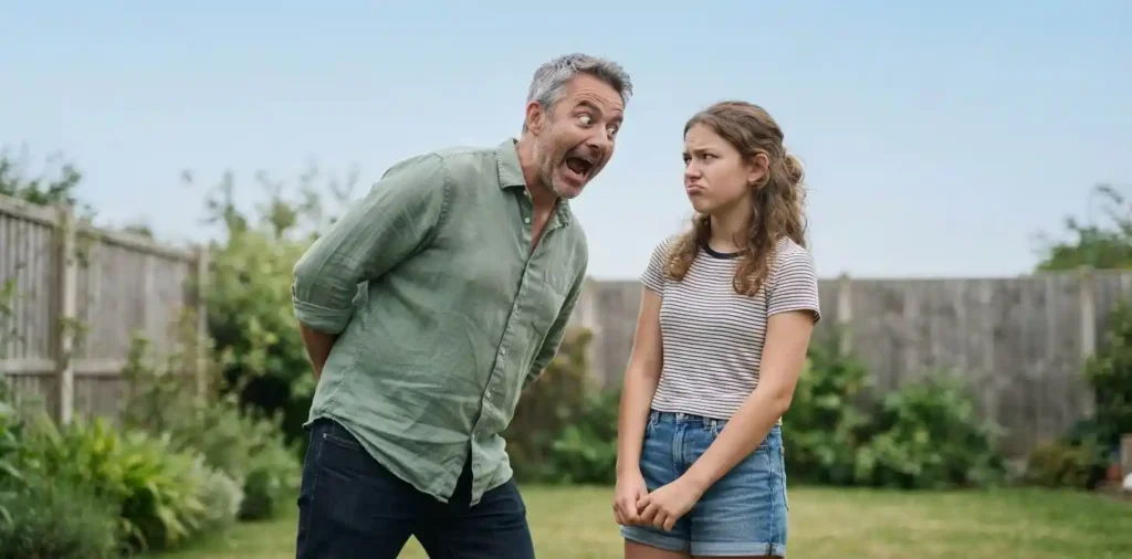 Father and daughter laughing together outdoors